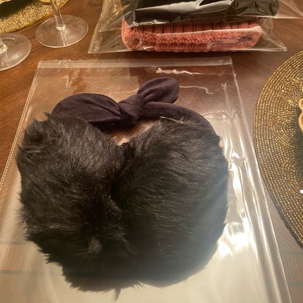 New in Packaging. Women’s Black Faux Fur Earmuffs with a Bow.